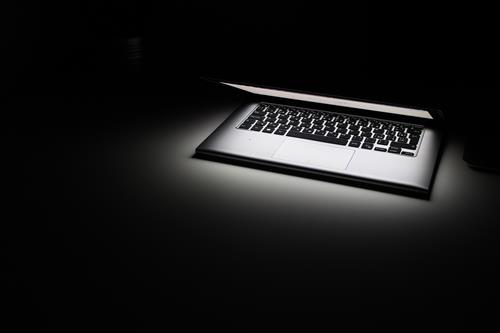 Glowing laptop and keyboard