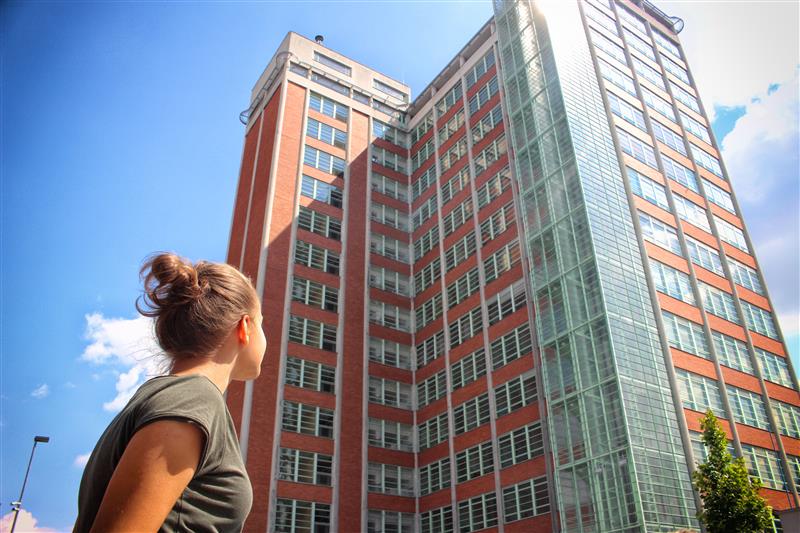 Young woman looking at building in the city